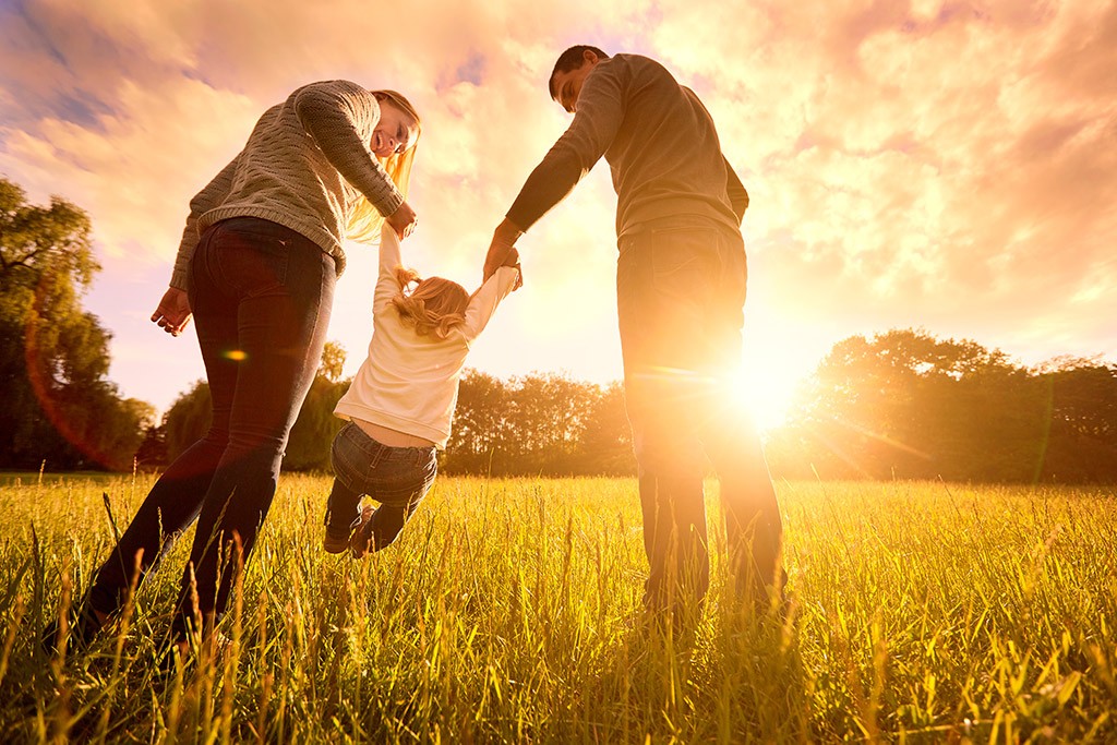 family running in a field and happy with their insurance choices family running in a field and happy with their insurance choices