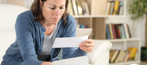serious adult woman reading the mail
