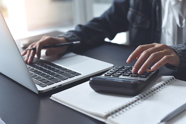 man using a calculator to determine his premiums